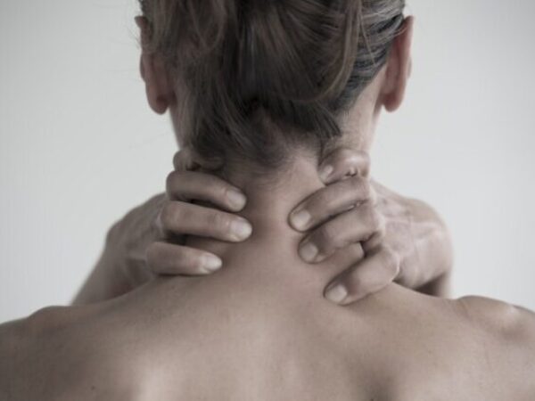 A closeup shot of a female having a neck pain