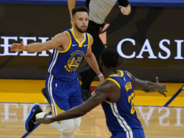 Golden State Warriors guard Stephen Curry, top, celebrates with forward Draymond Green during the second half of an NBA basketball game against the Cleveland Cavaliers in San Francisco, Monday, Feb. 15, 2021. (AP Photo/Jeff Chiu)