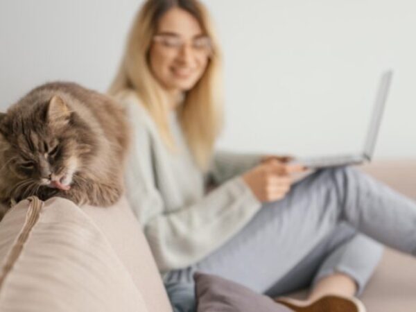 Woman sitting with cat in her living room.